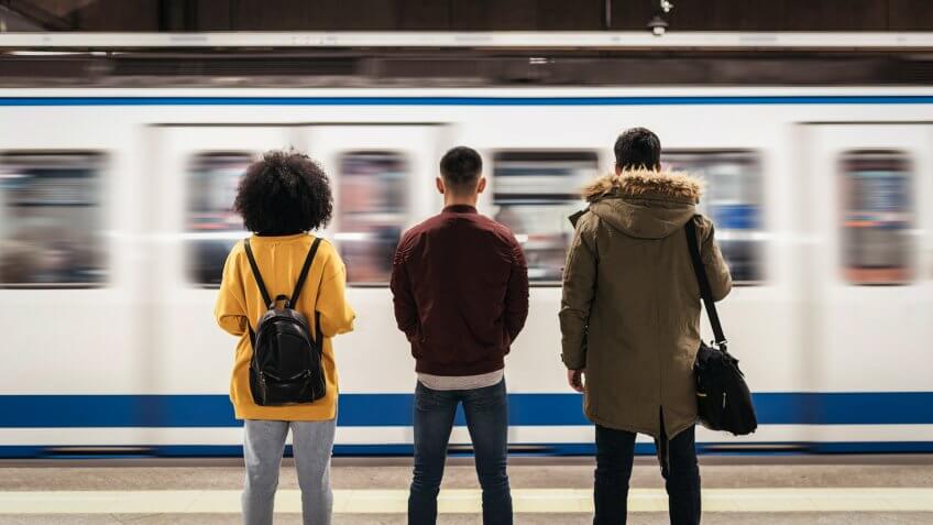 Group of friends waiting the train in the platform of subway station.