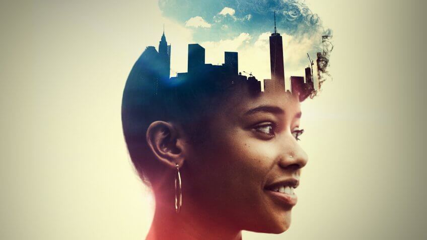 The profile of a woman's head, a New York City skyline double exposed with the image.