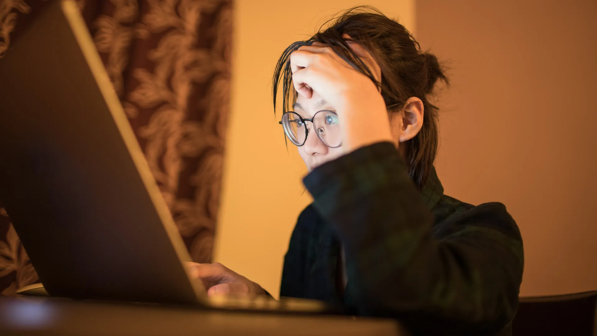 female college students using laptop late at night in search for information online.