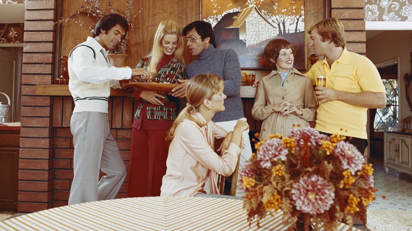 1973, Adults Only, Bonding, Caucasian Appearance, Cheerful, Colour, Flower, Food And Drink, Happiness, Holding, Horizontal, Indoors, Jumper, Liqueur, Looking Away, Medium Group Of People, Mid Adult, Photography, Refreshment, Snack, Standing, Table, Talking, Toothy Smile, Tray, Vase, Waist Up, Young Adult, Young Women, blonde hair, casual, enjoyment, friendship, glass, heterosexual couple, living room, mid adult men, party, sitting, three quarter length, togetherness