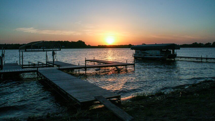 Sunset on a dock with pontoon boat on Lake Reno in Alexandria, Minnesota - Image.