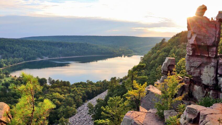 Areal view on the South shore beach and lake from rocky ice age hiking trail during sunset.