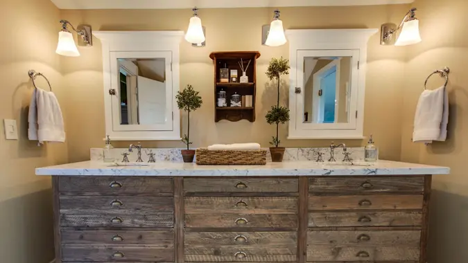 https://cdn.gobankingrates.com/wp-content/uploads/2019/10/Bathroom-cabinets-and-marble-top-vanity-counter-iStock-171210592.jpg?webp=1&w=675&quality=75