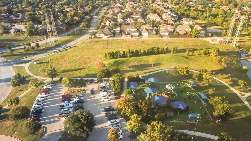 Top view playground near residential neighborhood with overhead power lines in Carrollton, suburbs Dallas, Texas, USA.