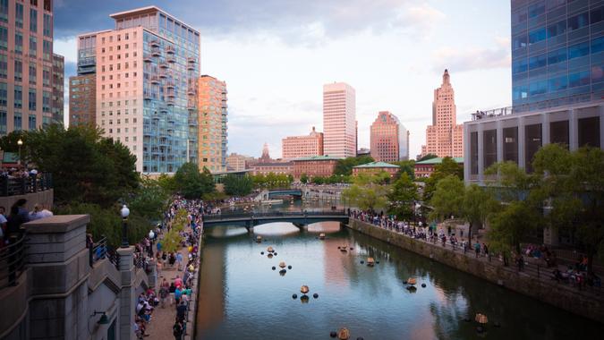 Crowds gather along Woonasquatucket river in Providence, RI in preparation for the summer series known as WaterFire, which consists of fiery wooden blocks placed along the river during the nighttime.