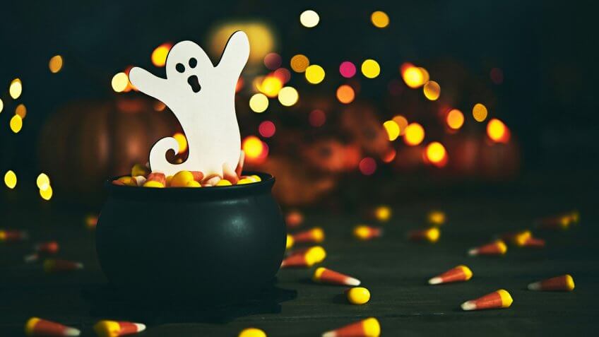 Halloween still life with ghost in cauldron.