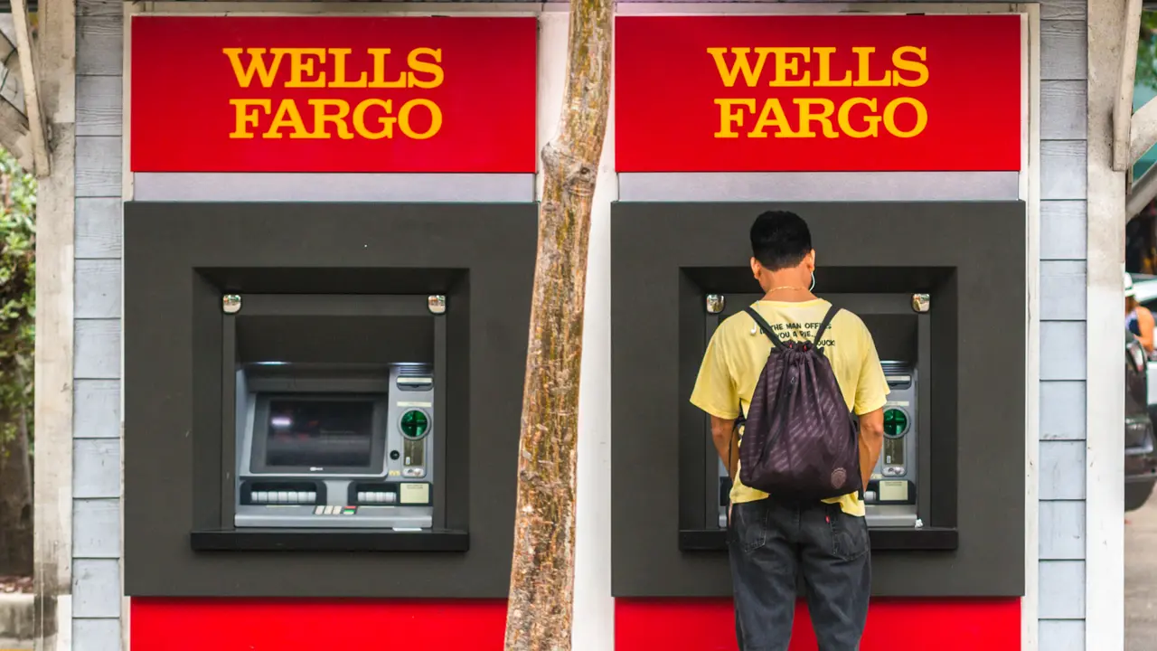Key West, USA  - January 9, 2015: Man using Wells Fargo ATM on Duval street, Key West.