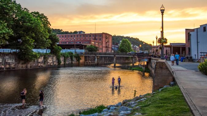 Prattville, Alabama/USA-June 12, 2019: A scenic view of people enjoying Autauga Creek and the Creekwalk area of Prattville during a beautiful golden sunset on a warm summer evening.