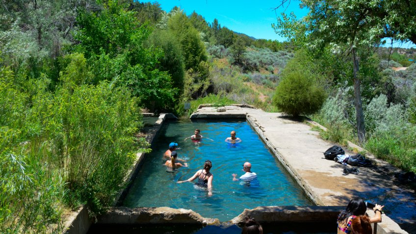 Tourists and Locals indulging in the Hot Springs near Llano Quemado, New Mexico.