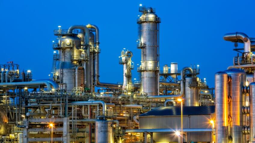Petrochemical plant illuminated at twilight.
