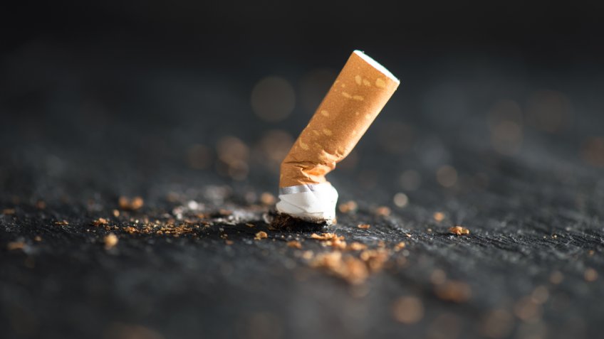Cigarette butt on abstract background.