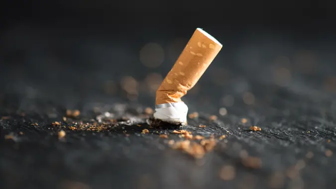 Cigarette butt on abstract background.