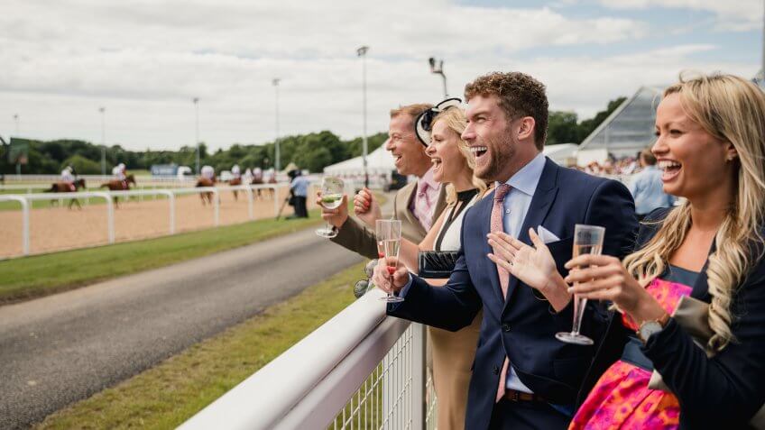 Couples enjoying a day at the races.