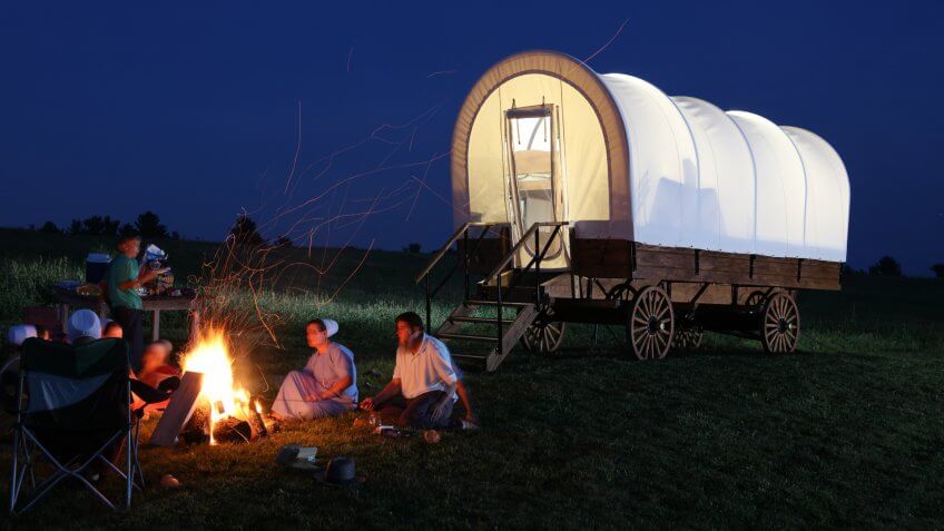 covered wagon next to camp fire