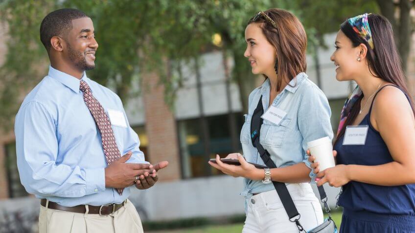 Young college student studying class schedule or campus map.