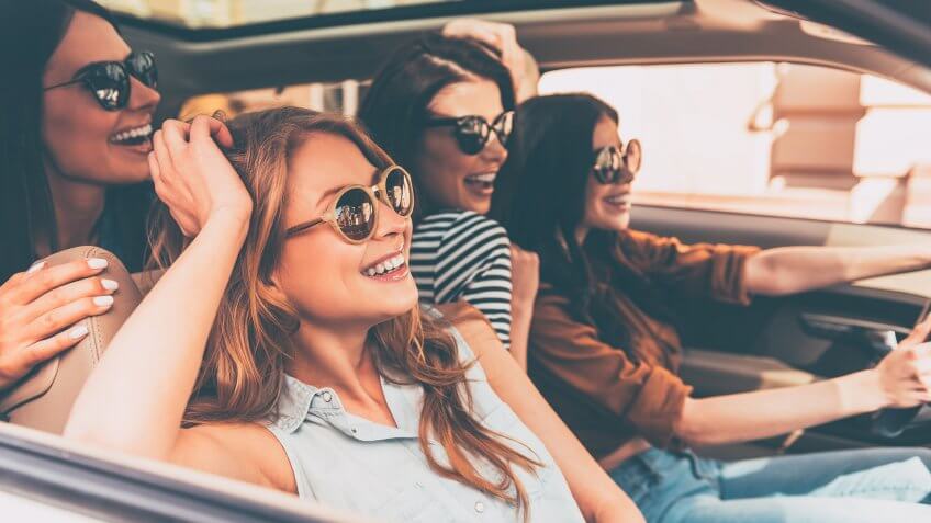 girls driving car on road trip