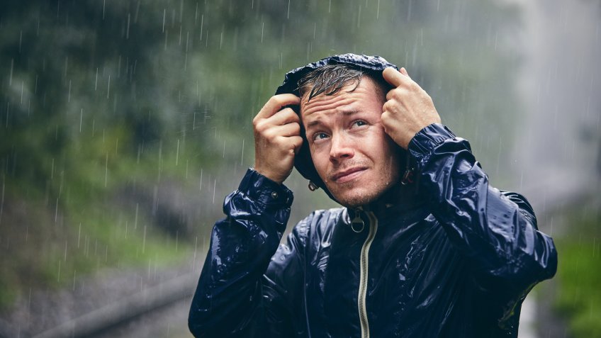 guy getting drenched in the rain