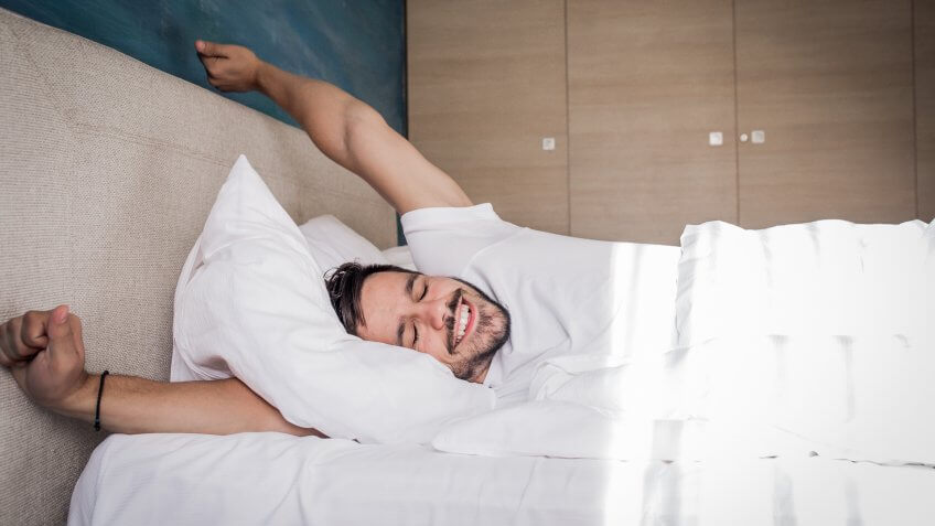 the man is going to bed in the morning with a smile on his face.