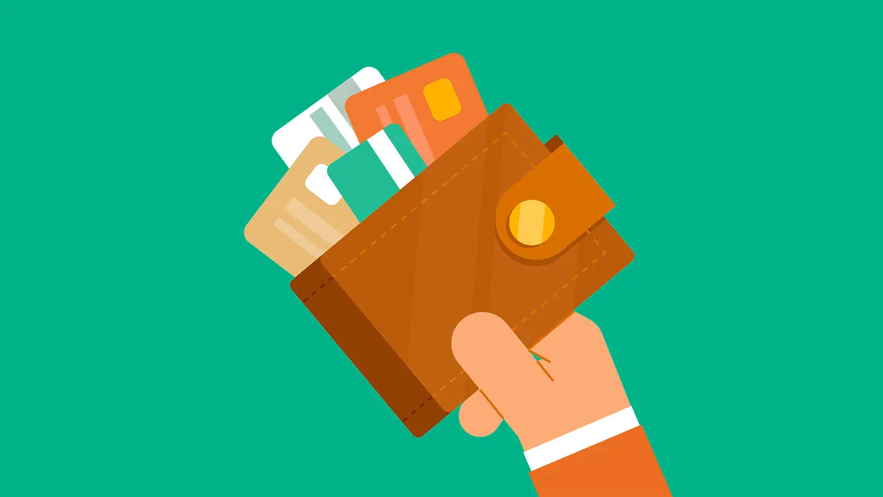 Businessman holding wallet full of credit cards.