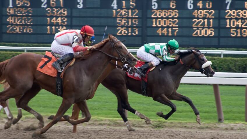 horse jockeys racing horses