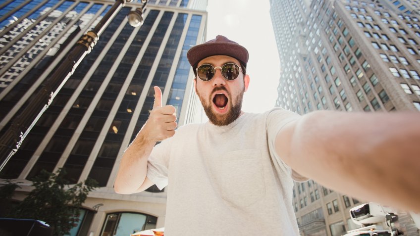 influencer taking selfie in city