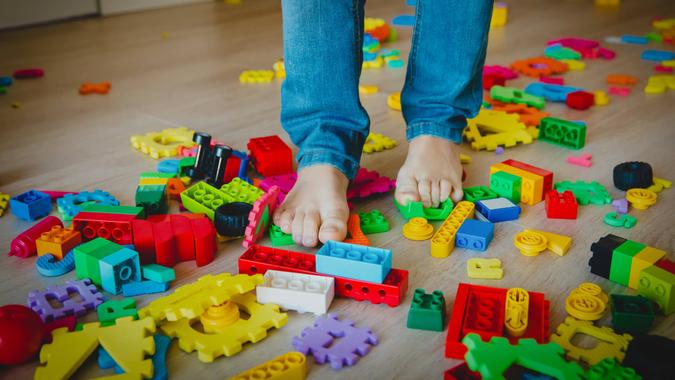abundance too much toys- little boy steps on toys trying to go through.