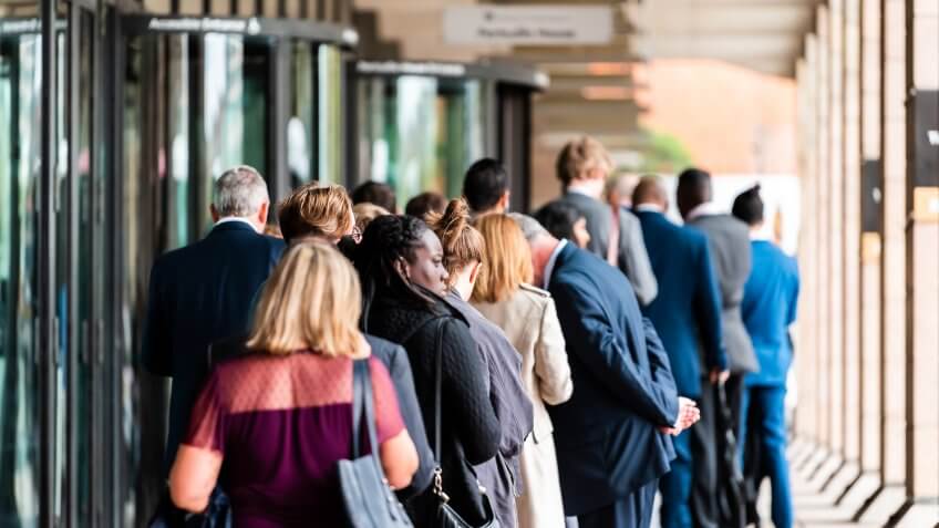 London, UK - September 12, 2018: People many crowd crowded standing in line queue to Westminster station cafe restaurant building on commute.