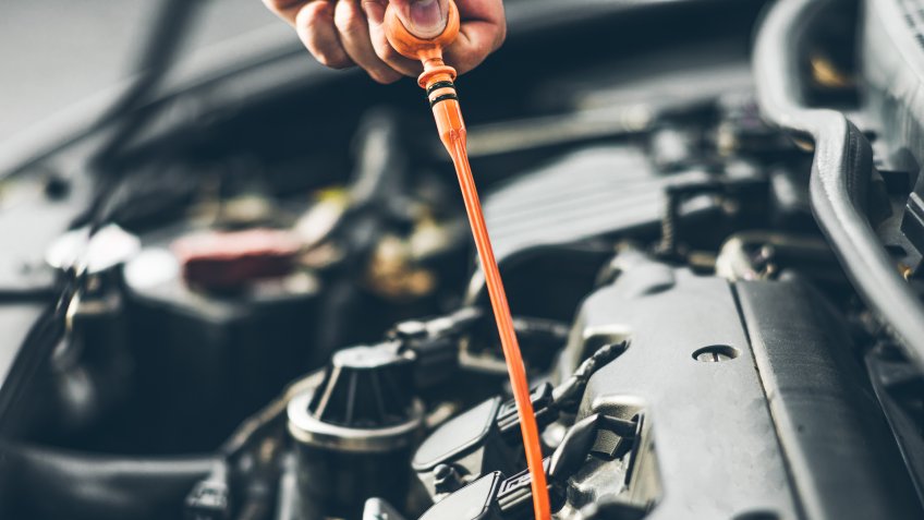 mechanic checking oil level