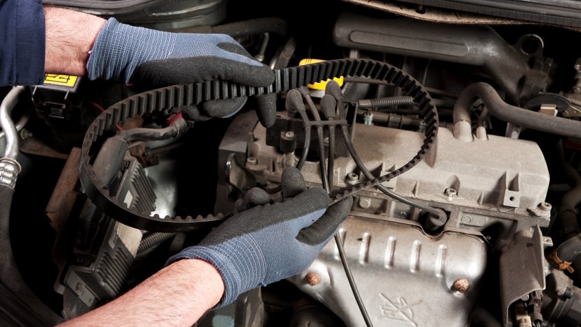 mechanic with engine belt