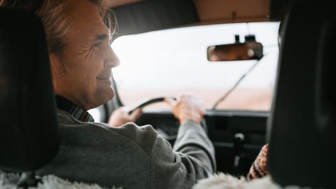 Lovely middle age couple driving by car.