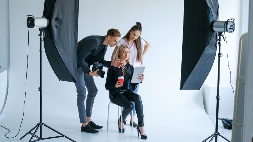 model being directed by photographer in studio
