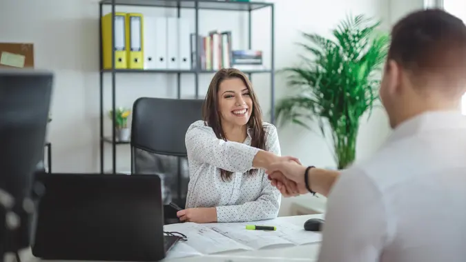 Young successful forewoman interviewing a job candidate at her office.