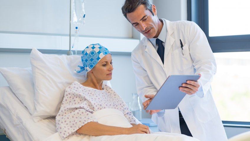 Doctor telling to patient woman the results of her medical tests.