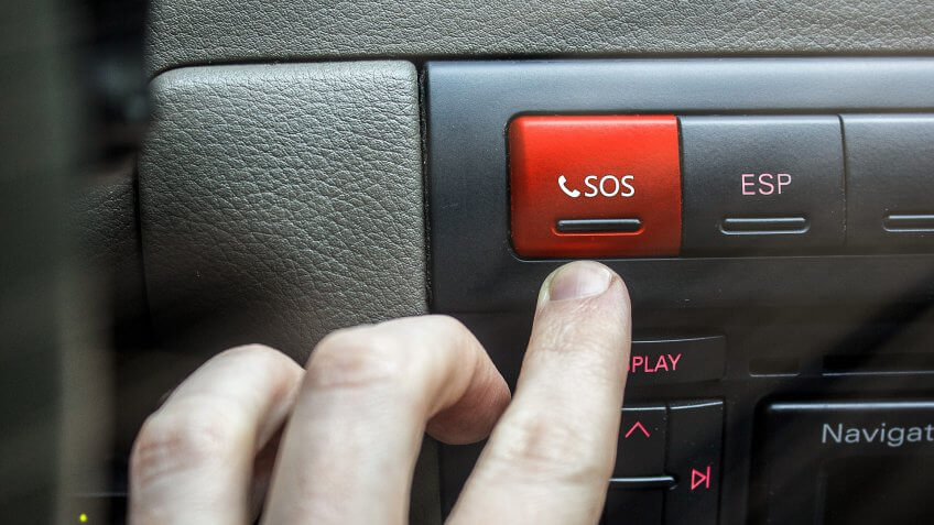 person pressing SOS button in car