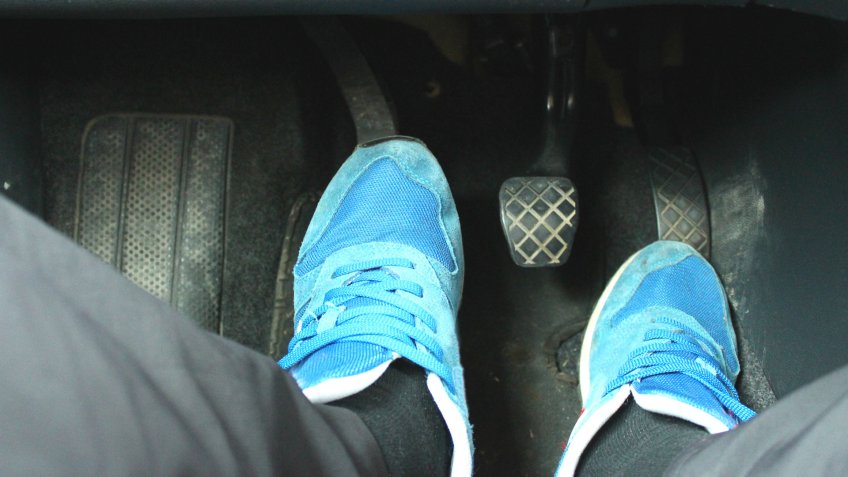 person riding the clutch in car