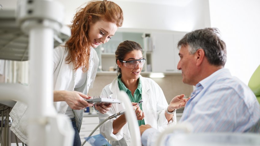 physicians assistant with doctor and patient