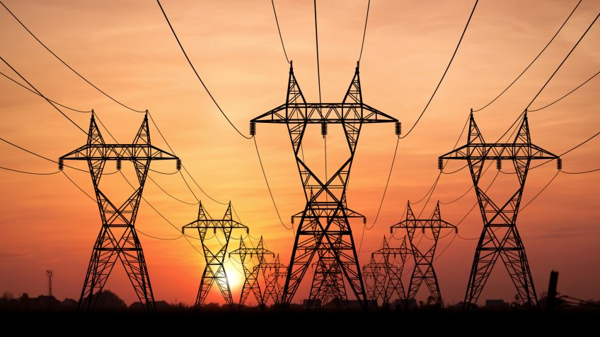 Electricity Pylons at sunset on background.