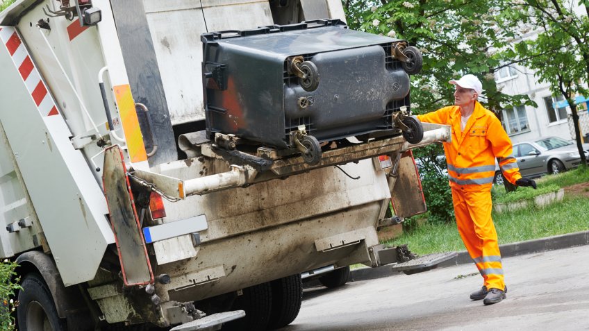 Worker of municipal recycling garbage collector truck loading waste and trash bin - Image.