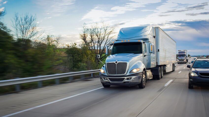 shipping truck driving on highway
