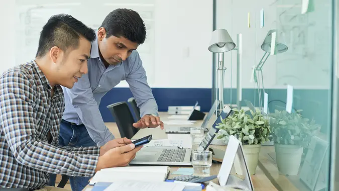 Team of UX designers discussing interface of new mobile application.