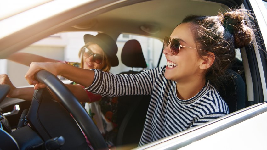 two friends driving on road trip