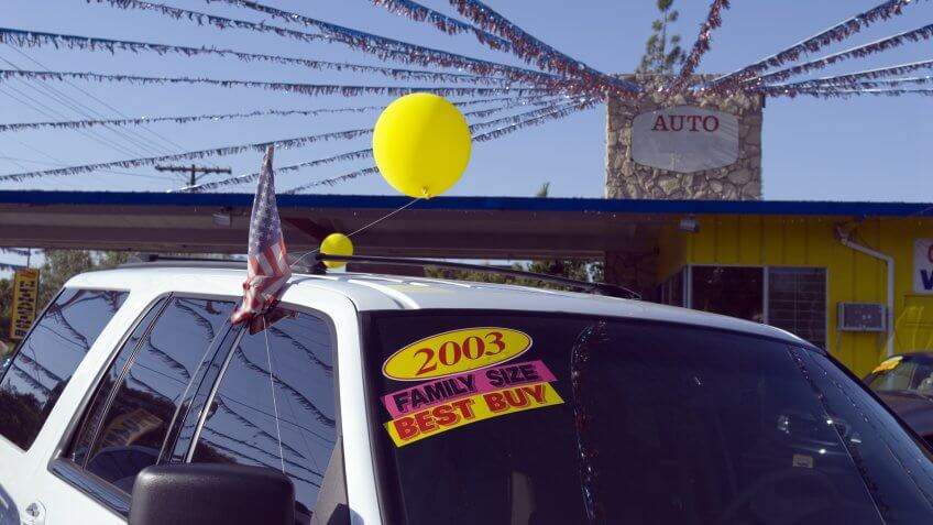used car dealership with old car