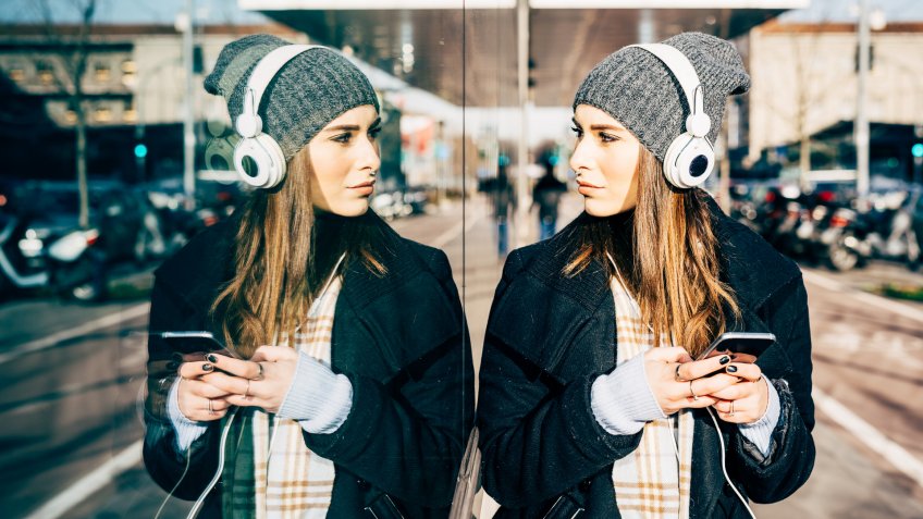 woman looking in mirrored wall
