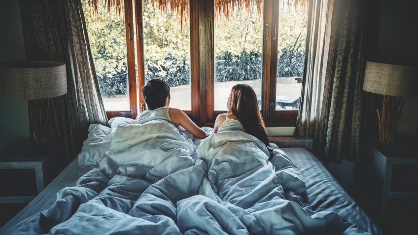 Couple love in bed on Holiday time Honeymoon vacation summer concept.