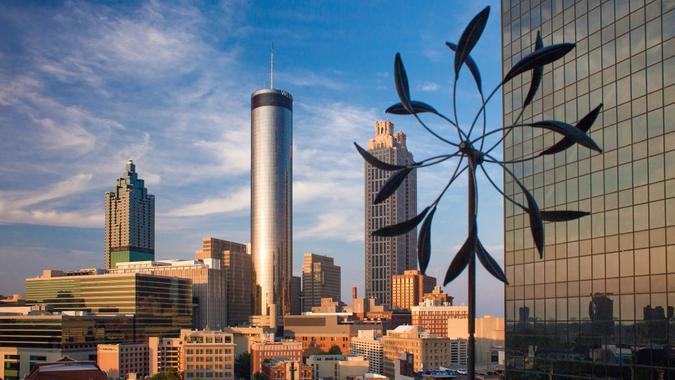 Atlanta, Georgia, USA – July 26, 2015: Sunset panoramic aerial view of Atlanta skyline, with the Westin Peachtree Plaza skyscraper at its center, with a mobile sculpture of the SkyLounge rooftop terra - Image.