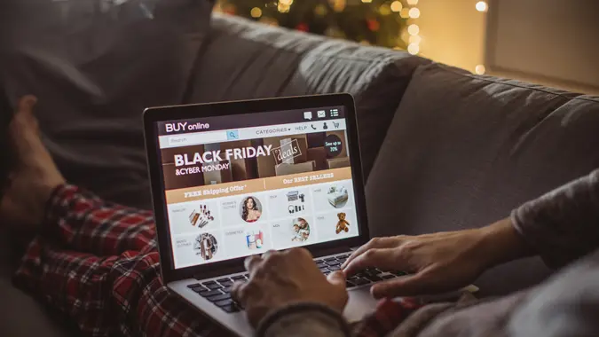 Man shopping online on his laptop, it is Christmas time for shopping.