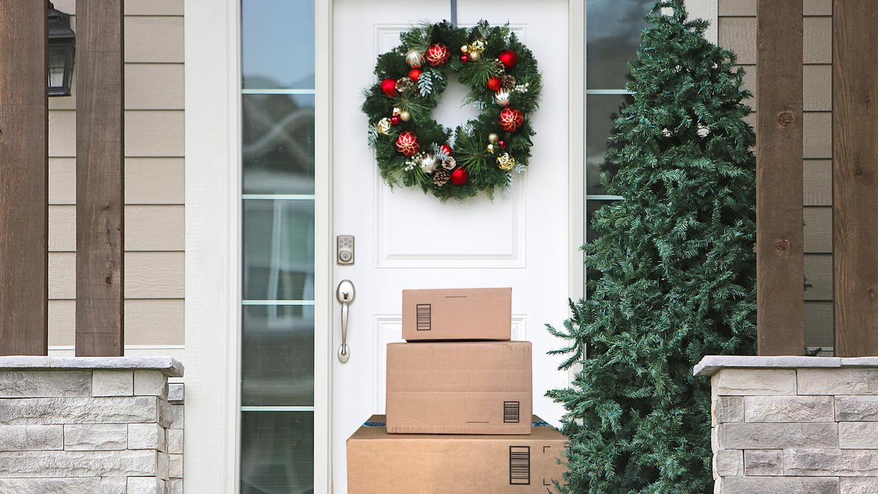 front door with christmas wreath and packages.