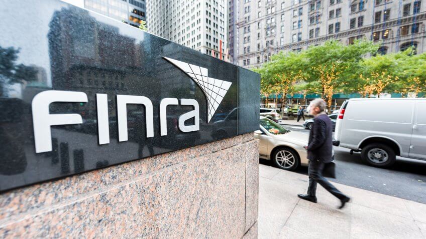 New York City, USA - October 30, 2017: Sign on the building of Financial Industry Regulatory Authority, or Finra, in Manhattan NYC lower financial district downtown, businessman man walking - Image.