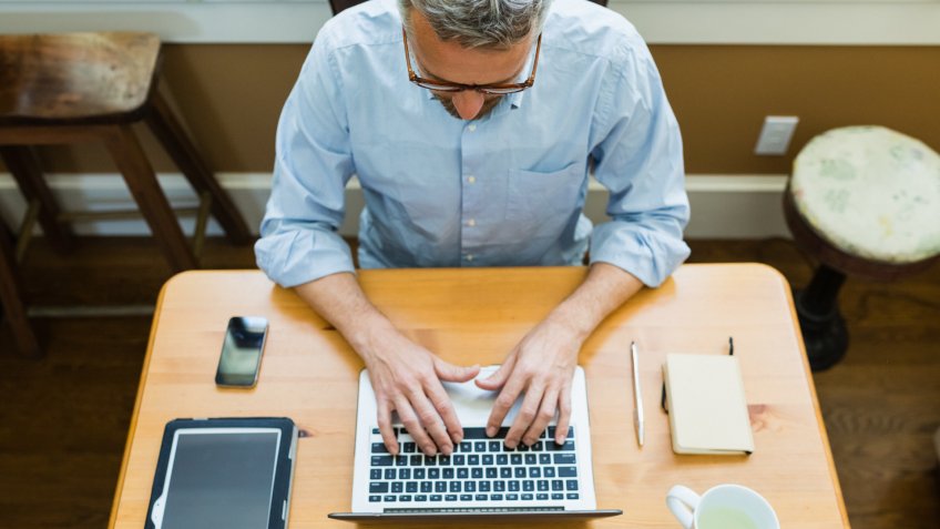 man working using laptop at home.