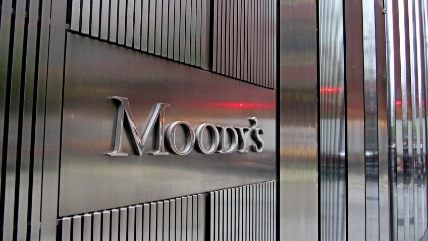 New York, NY/USA-May 3, 2019: Red light is reflected in the stainless steel facade of 7 World Trade Center and the Moody's Investor Services sign.